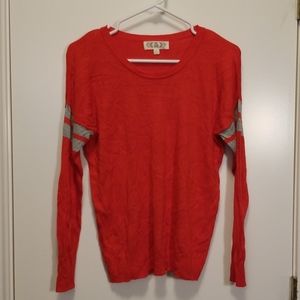 Red sweater with grey stripes on sleeves